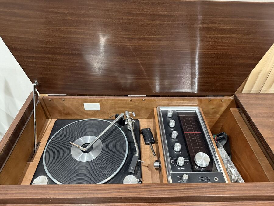 Wood console stereo opened to show the turntable and receiver