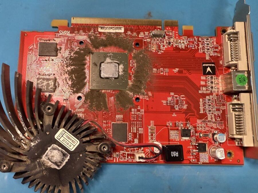 Radeon graphics card with the cooler off and dried-out thermal paste on the chip