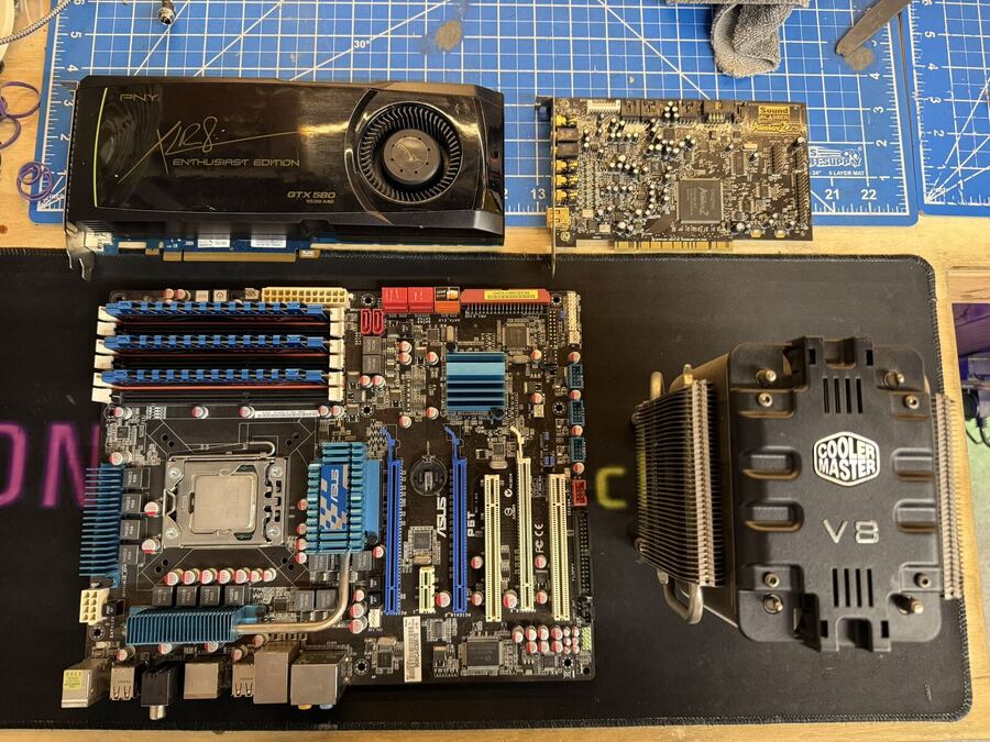 ASUS motherboard, graphics card and Cooler Master tower cooler laid out before a build