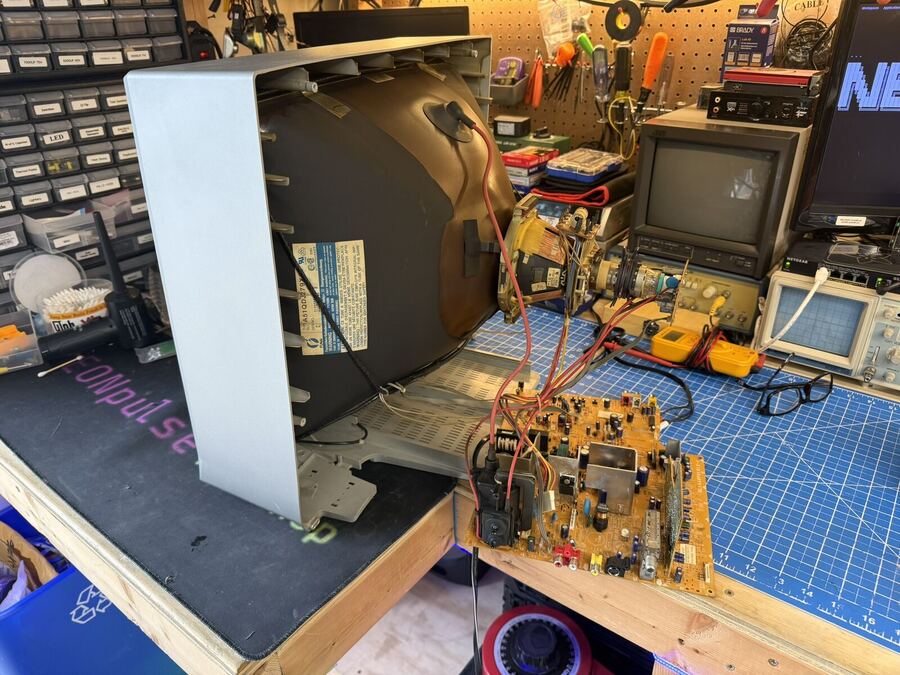 TV and VCR combo opened on the bench with the tape mechanism out