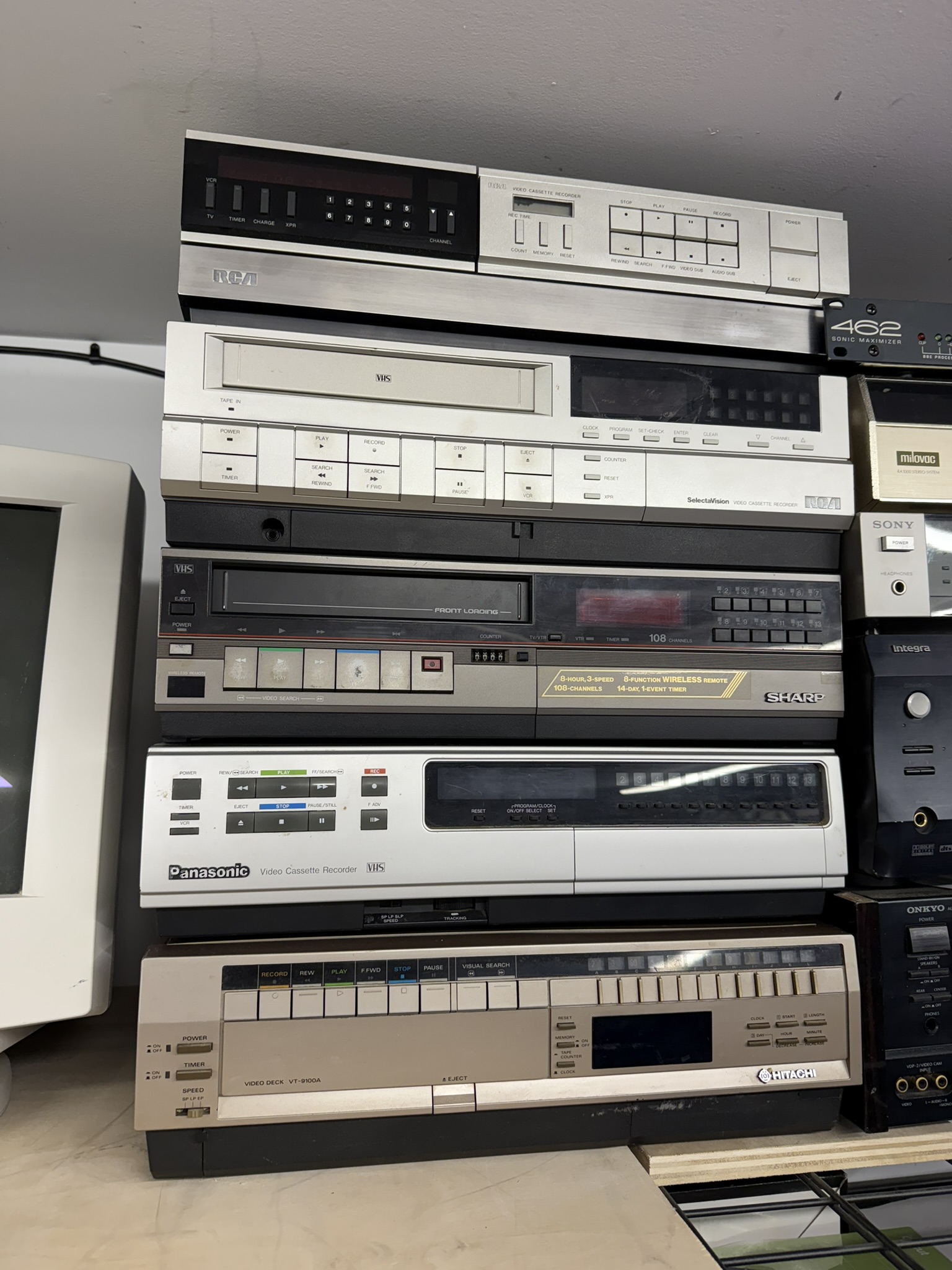 Stack of vintage VCRs ready for repair